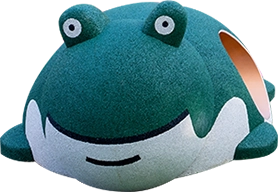 A playground structure shaped like a green frog with a smiling face and two large eyes on top.